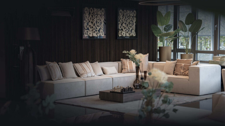Aesthetify prices – Lounge area with a light sofa landscape, art prints and a chess set